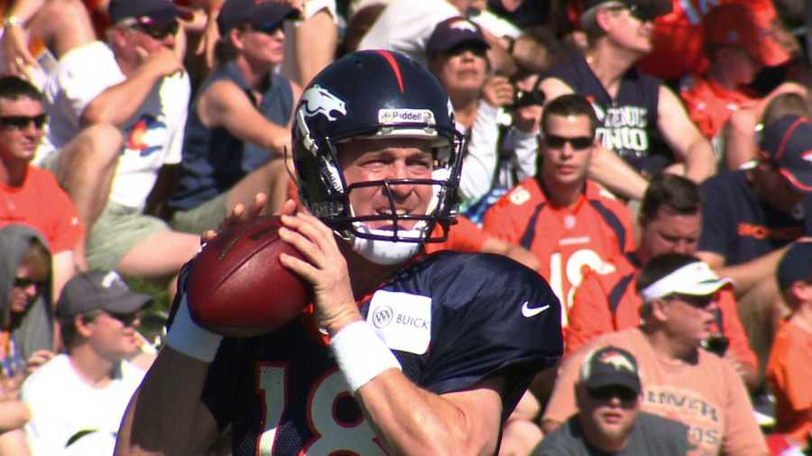 Large crowd watches Peyton Manning throw at Broncos training camp. July 30, 2012