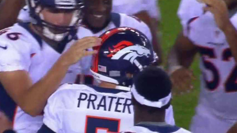 Matt Prater is embraced by his teammates after a game-winning kick that lifted the Denver Broncos to a 16-13 win over the Arizona Cardinals on Aug. 30, 2012.