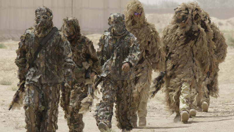 Special operations soldiers don Ghillie suits -- camouflage outfits designed to resemble heavy foliage -- in Iraq. (CNN)