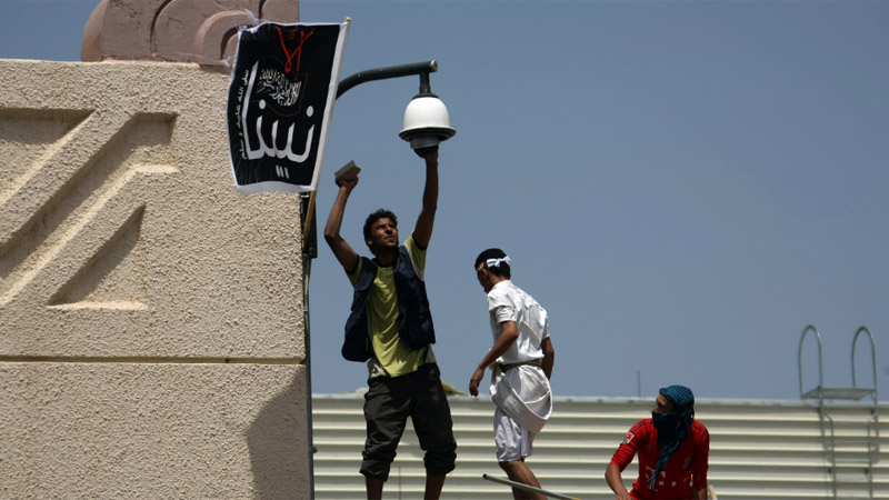 Yemeni protesters try to break the security camera at the U.S. Embassy in Sanaa on Thursday