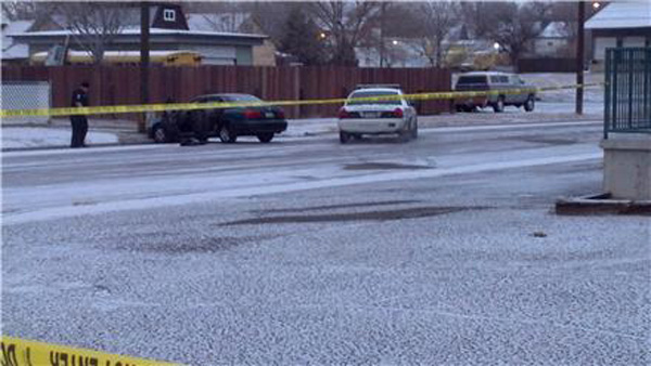 Police investigate a suspect's vehicle following an officer-involved shooting on Jan. 1, 2012. (Photo: KXRM)