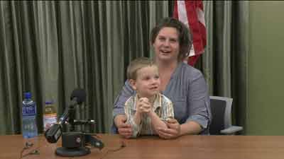 Brandy Turner and her son Luke at a news conference at Denver International Airport.