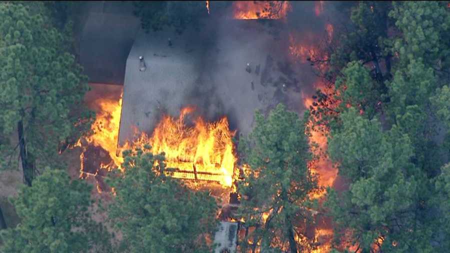 A small group of firefighters in the Black Forest area dug trenches and fought with backs against a wall to save School In The Woods, officials said. The Black Forest Fire has so far claimed at least 360 other buildings.