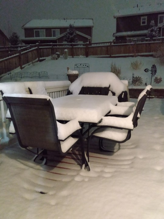 Patio furniture covered in snow in Castle Rock