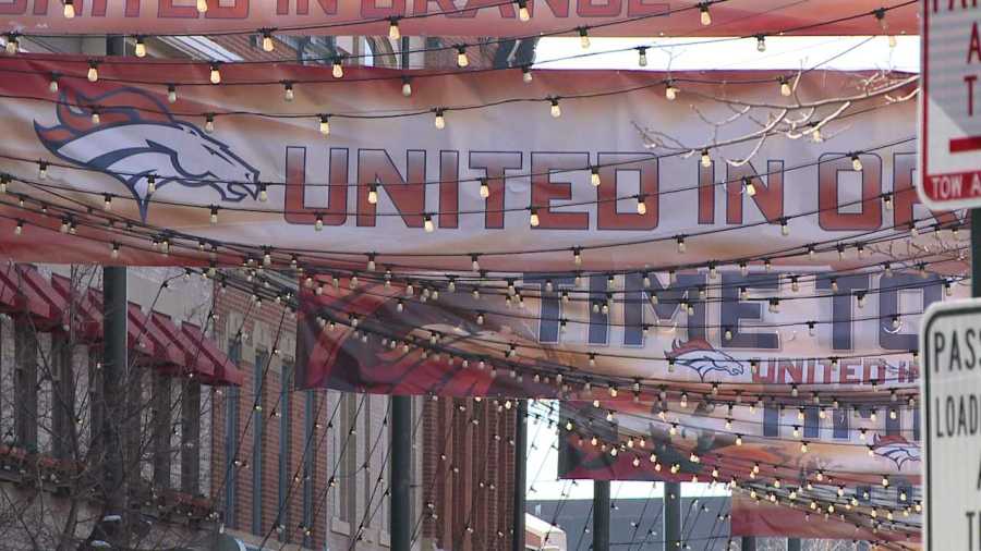 United in Orange signs hang in Larimer Square the day after the Super Bowl