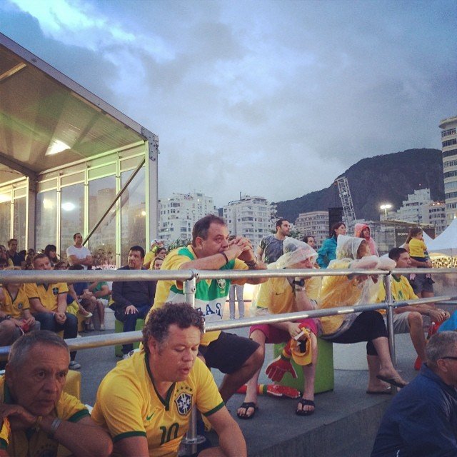 Devastated Brazil fans take a moment after Germany pummeled their team 7-1 Tuesday, July 8, 2014.