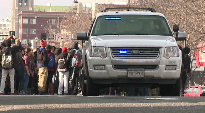 Protesters stopped to watch as the four officers paramedics treated the four officers.