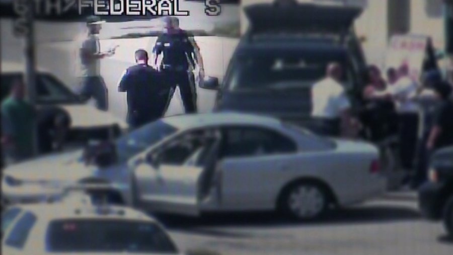 Levi Fraiser, highlighted in the upper left, carries his tablet to a Denver police SUV in this HALO camera image