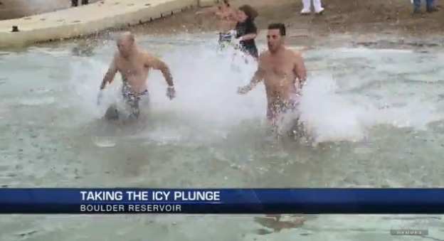 Two men run into Boulder Reservoir for the Polar Plunge in 2014.