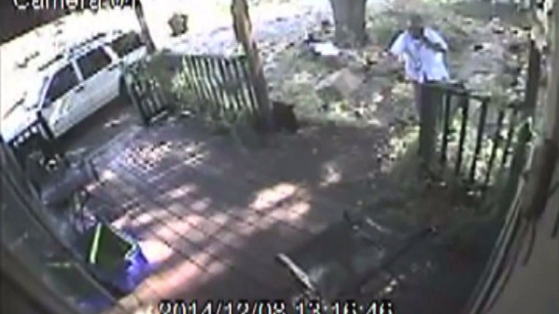 USPS worker throws a package deliver to a door