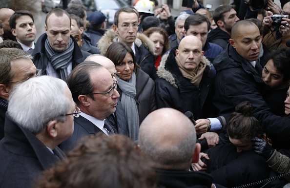 French President Francois Hollande (C) speaks to the press after arriving at the headquarters of the French satirical newspaper Charlie Hebdo in Paris on January 7, 2015, after armed gunmen stormed the offices leaving eleven dead, including two police officers, according to sources close to the investigation. (Photo: KENZO TRIBOUILLARD/AFP/Getty Images)