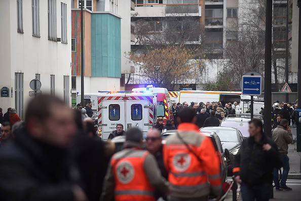 Ambulances and police officers gather in front of the offices of the French satirical newspaper Charlie Hebdo. (Photo: Antoine Antoniol/Getty Images)