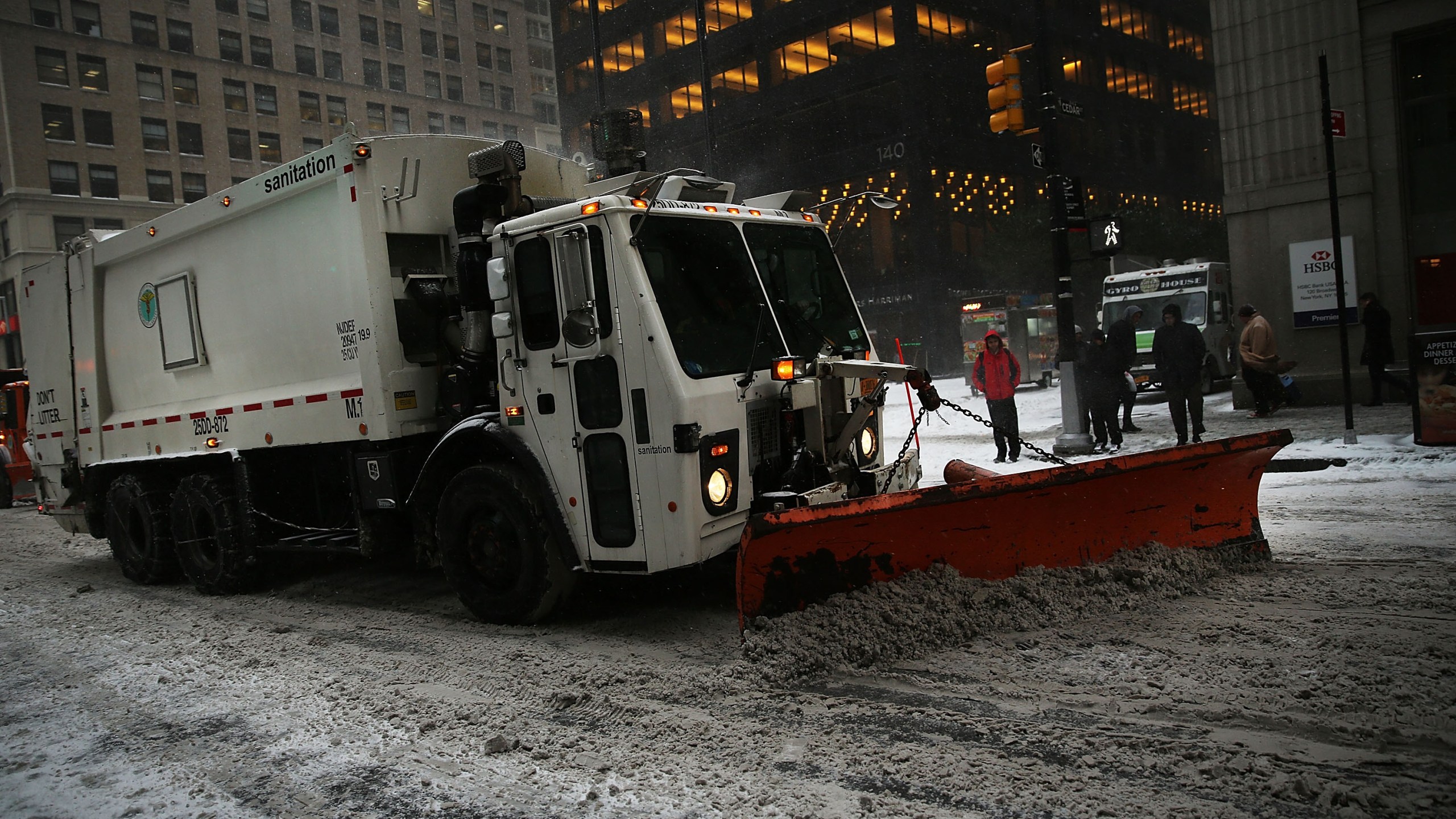 A plow travels down a city street during heavy snow in the financial district of Manhattan on January 26, 2015 in New York City.(Photo by: Spencer Platt/Getty Images)