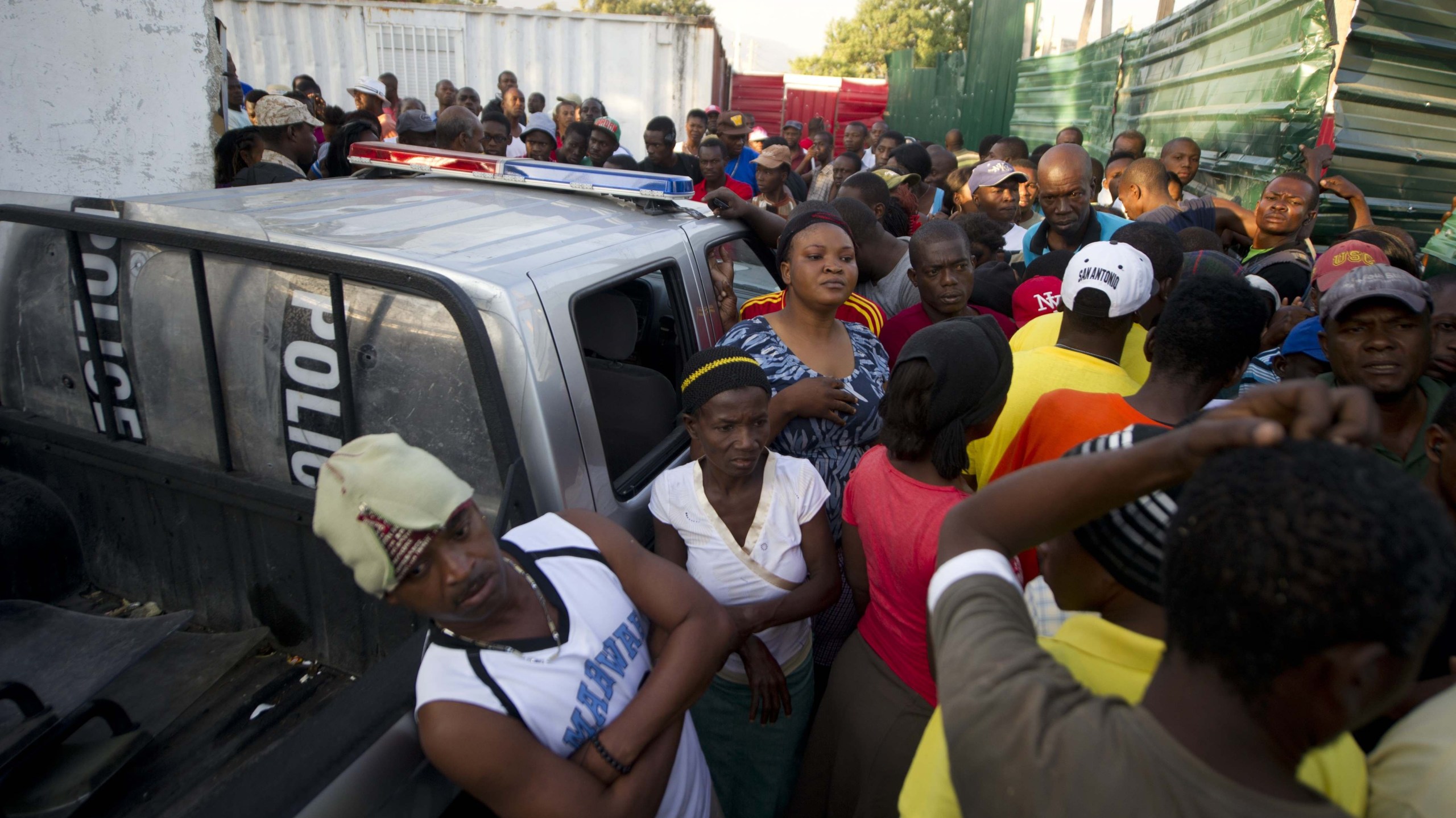 Families wait February 17, 2015 for word on loved ones at the General Hospital of Port-au-Prince after an accident during celebrations of the National Carnival of Haiti. A high-voltage cable fell on a float during a Carnival parade in Port-au-Prince early Tuesday, killing at least 15 people as thousands watched, emergency officials said. Dozens more were injured in the accident, which occurred at around 2:48 am (0748 GMT) on the second day of Carnival, Communications Minister Rotchild Francois said in a statement. Family members besieged a main hospital complex in Port-au-Prince to find their loved ones as doctors struggled to treat the injured. AFP PHOTO/HECTOR RETAMAL (Photo credit should read HECTOR RETAMAL/AFP/Getty Images)