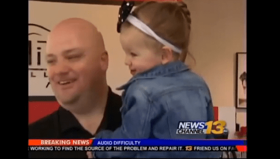 Greg Wickherst, former Navy Technician, braids his daughter's hair.