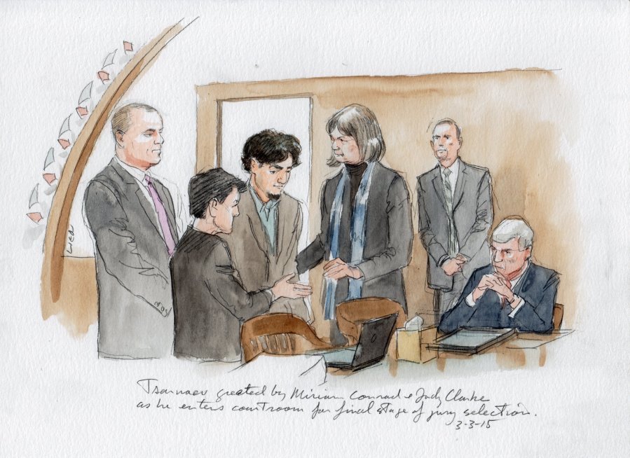 Tsarnaev and lawyers stand before pool of qualified jurors before seating jury. L to R : Weinreb, Pellegrini, Conrad, Tsarnaev, Clarke, Bruck, and seated US Marshals.