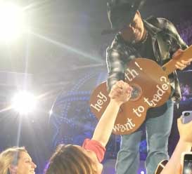 Garth Brooks trades for a cardboard guitar during concert in Sacramento