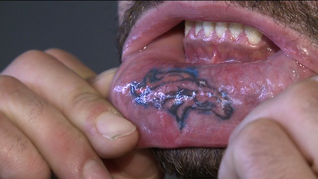 Fan Daniel Mascarenas has Broncos logo tattooed to his lower lip