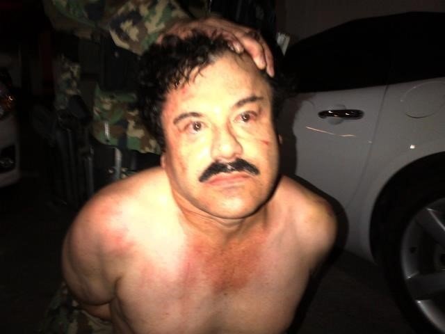 El Chapo under arrest in 2014. A manhunt has been launched to find Mexican drug kingpin Joaquin Guzman after he escaped from prison, Mexico's National Security Commission said in a statement Saturday. Guards at the Altiplano Federal Prison found that Guzman, also known as "El Chapo," was missing during routine check. (Photo: CNN)