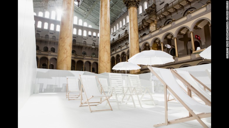 "The Beach" a 10,000-square-foot, stark-white installation includes lounge chairs and a concession stand. (Photo: Noah Kalina/National Building Museum)