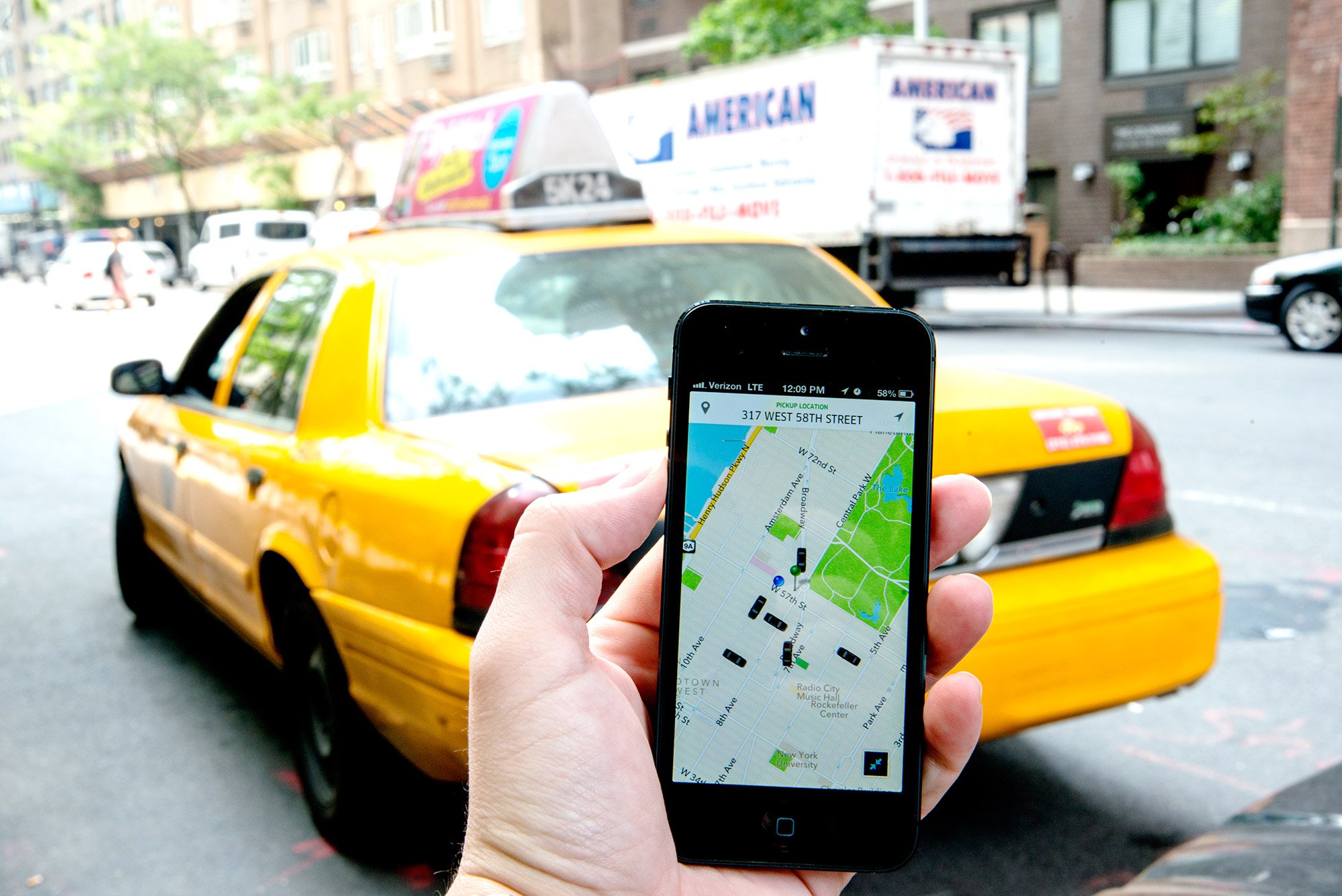 Uber, a ride sharing service, as seen through their iOS app near Central Park, New York, New York. A taxi is seen in the background. (Photo: CNN)