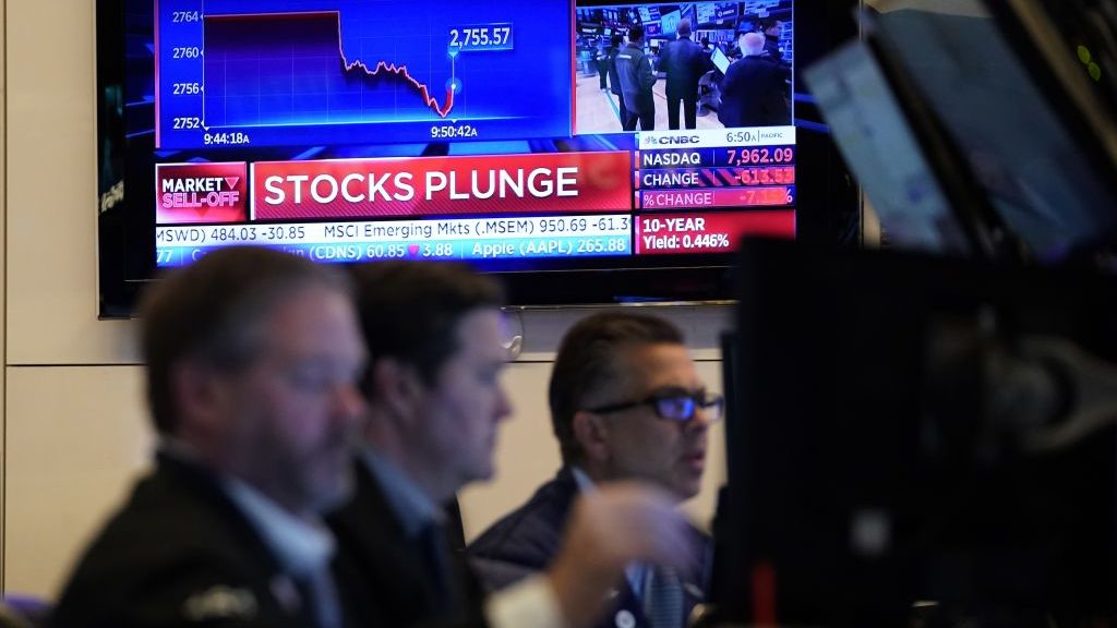 Traders work on the floor during the opening bell on the New York Stock Exchange on March 9, 2020.