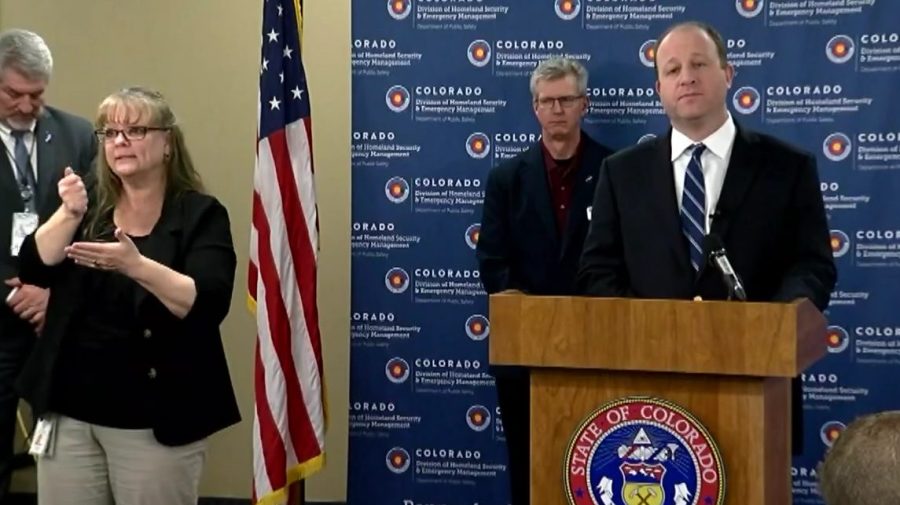 Colorado Gov. Jared Polis holds a news conference announcing a statewide stay-at-home order, on March 25, 2020.