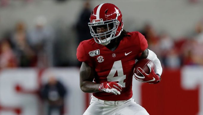 Jerry Jeudy #4 of the Alabama Crimson Tide pulls in this reception against Joe Foucha #7 of the Arkansas Razorbacks in the first half at Bryant-Denny Stadium on October 26, 2019 in Tuscaloosa, Alabama.