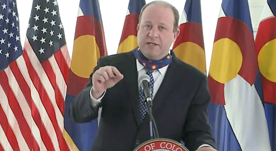 Gov. Jared Polis talks about what it'll take to reopen the state during a new conference on April 15.