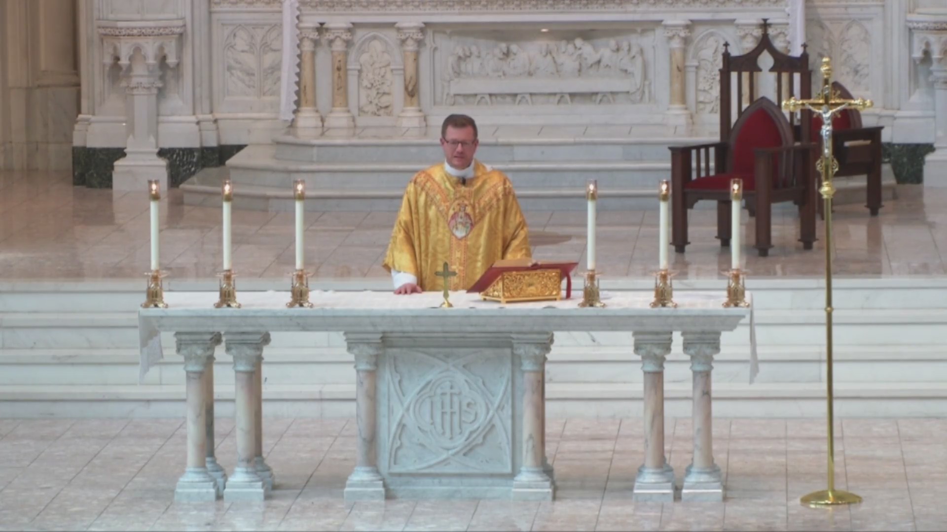 Fr. Randy Dollins holds a video Est Sunday Mass from the Cathedral Basilica of the Immaculate Conception in Denver.