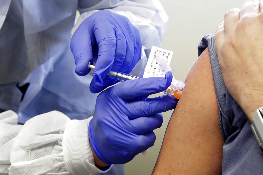 A patient receives a shot in the first-stage safety study clinical trial of a potential vaccine for COVID-19. A coronavirus vaccine is still months or years away, but groups that peddle misinformation about immunizations are already taking aim - and potentially eroding - confidence in what could be humanity’s best chance to defeat the virus.