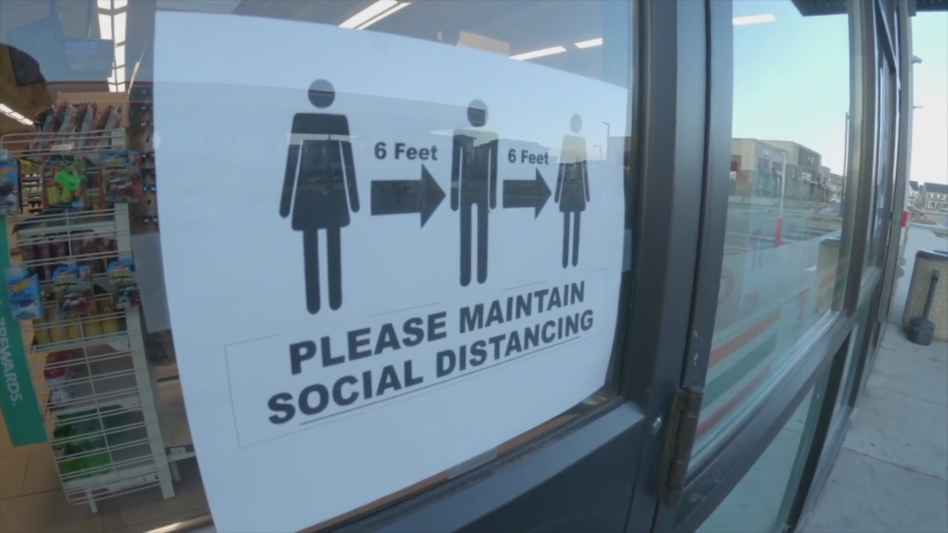 A sign reminds customers to social distance.