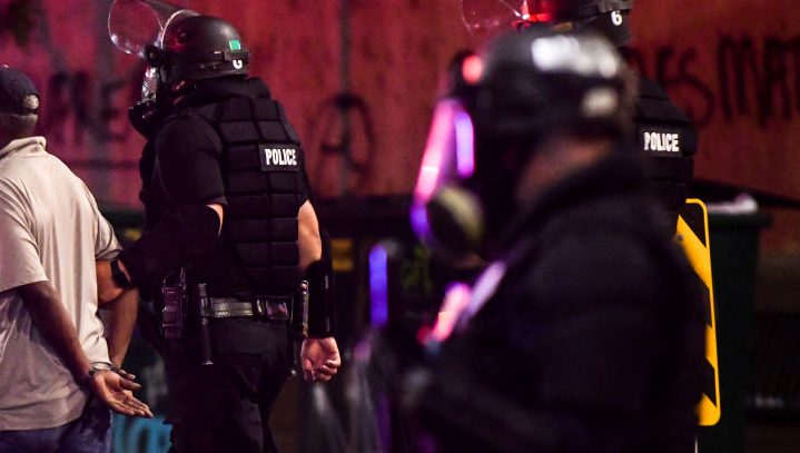 Police officers arrest a man during the fourth consecutive day of protests on May 31, 2020 in Denver.