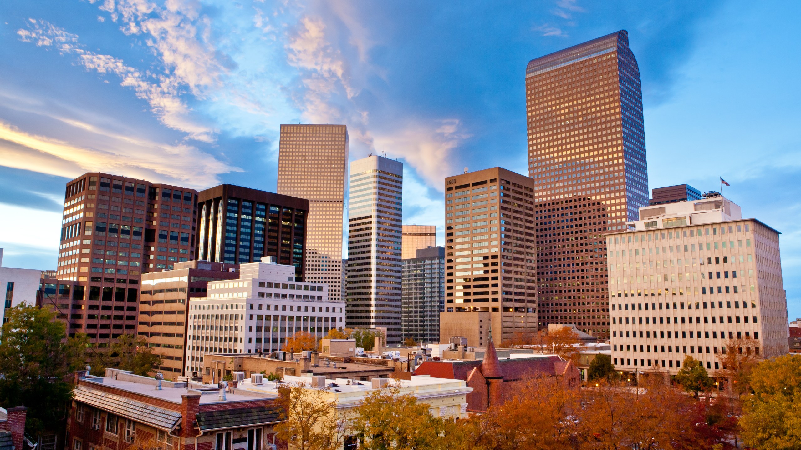 Sunset on an Autumn day over the downtown Denver skyline with wispy dramatic clouds reflecting in the buildings and skyscrapers