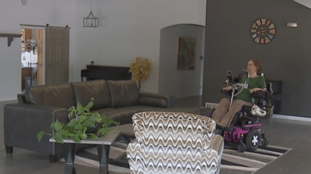 A woman in a wheelchair in a spacious living room