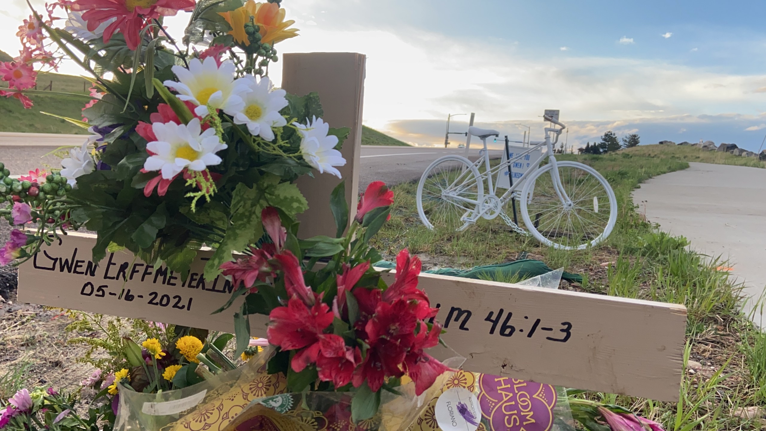 A ghost bike memorial adorned with flowers