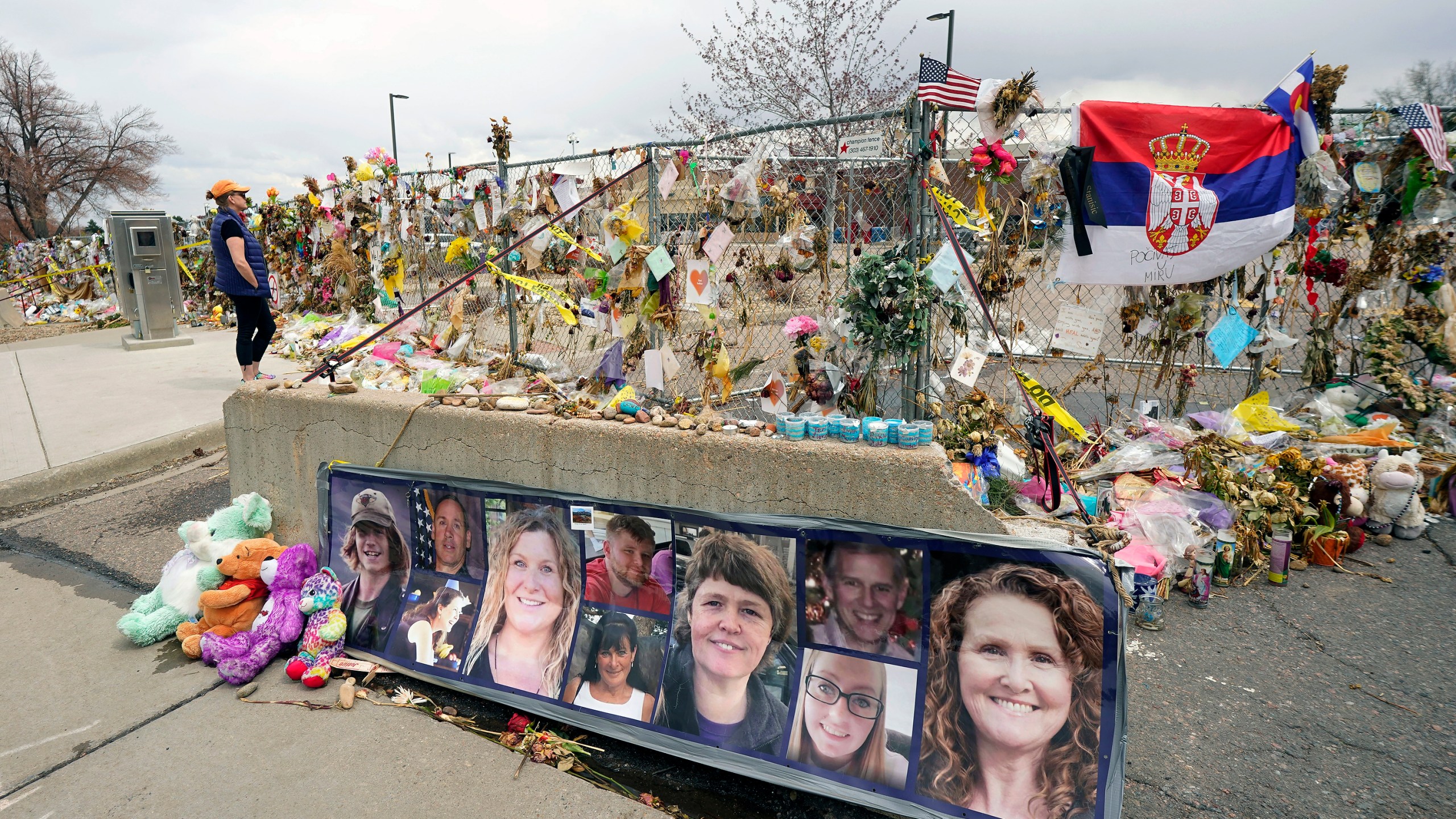 hotographs of the 10 victims of a mass shooting in a King Soopers grocery store are posted on a cement barrier outside the supermarket