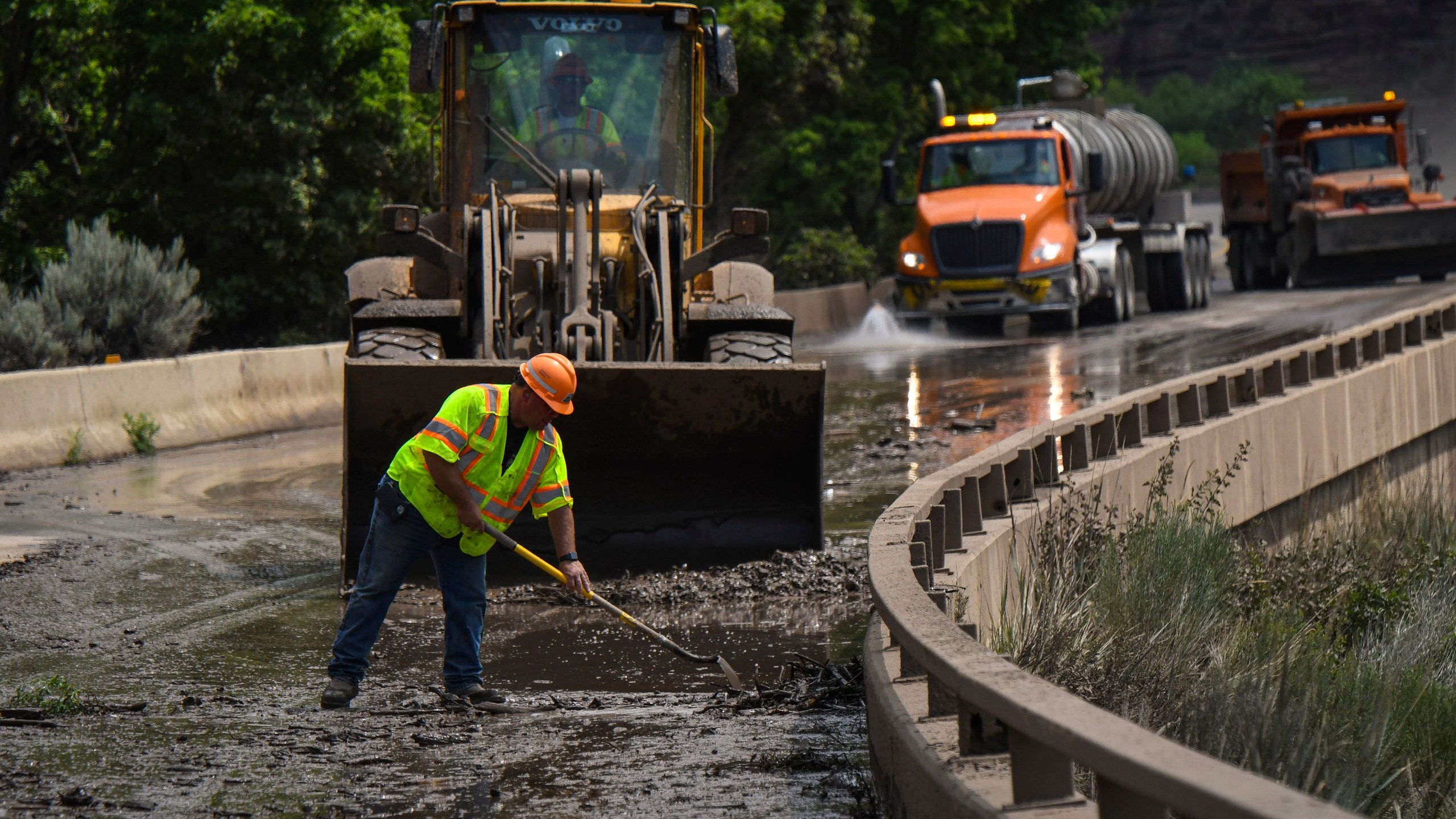 Colorado Department of Transportation crews work to clear mud and debris from the eastbound deck of Interstate 70 through Glenwood Canyon, Colo., near Bair Ranch after a flash flood.