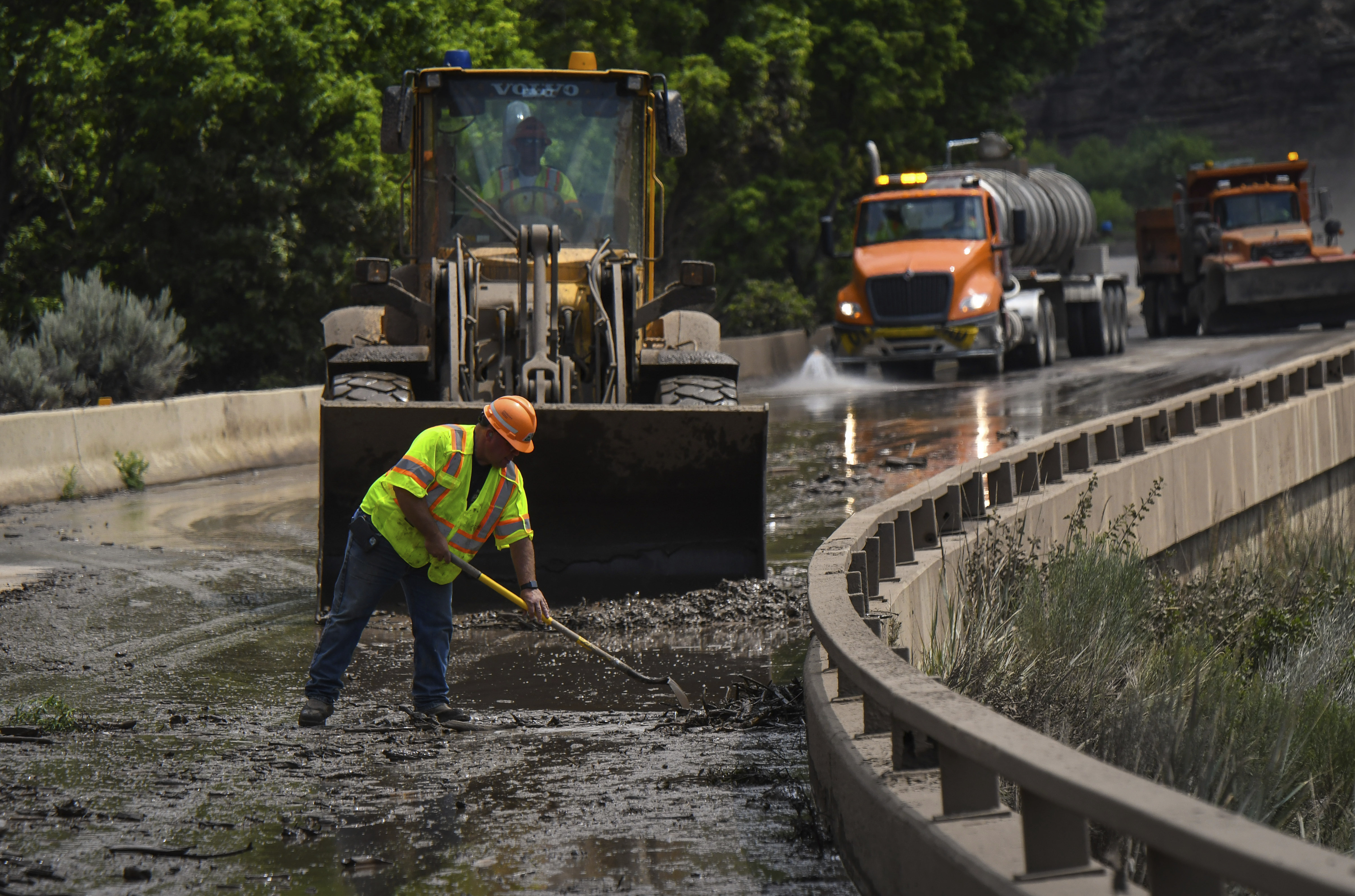 Colorado Department of Transportation crews work to clear mud and debris from the eastbound deck of Interstate 70 through Glenwood Canyon, Colo., near Bair Ranch after a flash flood.