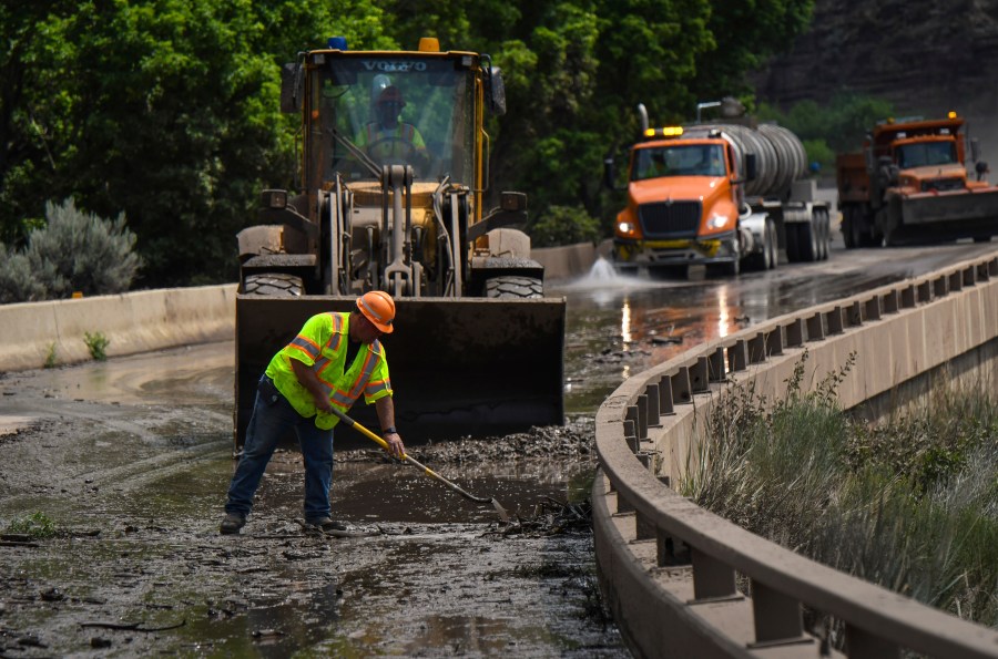 Colorado Department of Transportation crews work to clear mud and debris from the eastbound deck of Interstate 70 through Glenwood Canyon, Colo., near Bair Ranch after a flash flood.