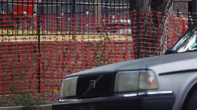 Orange plastic fencing along a parkway