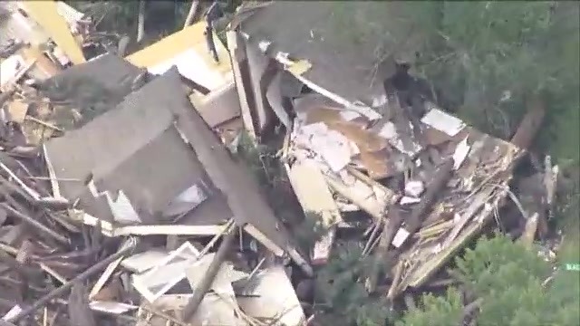 A house destroyed in pieces and bits from aerial view