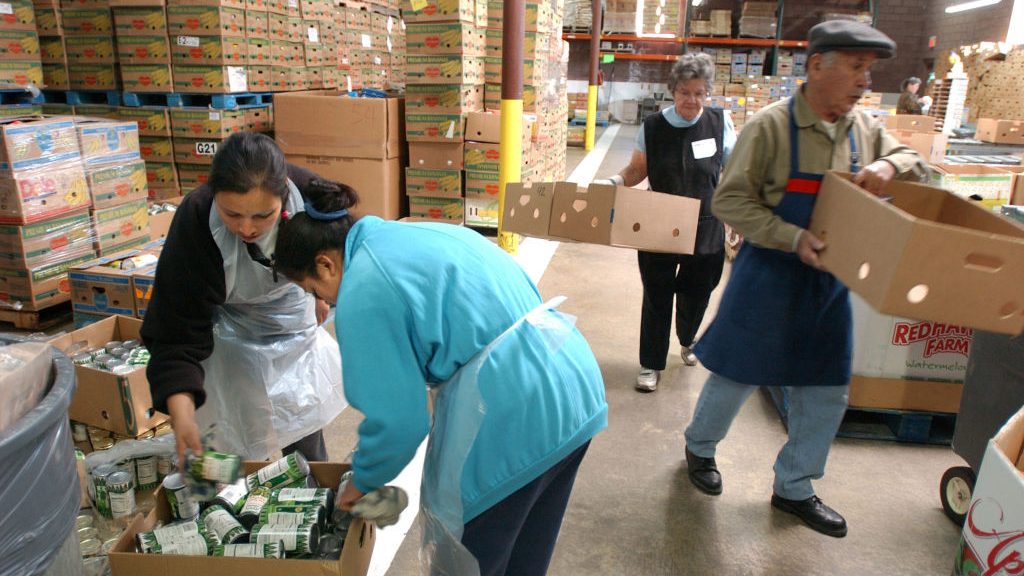 Volunteers in Denver sort donated food and move boxes at the Food Bank of the Rockies in this 2003 photo.