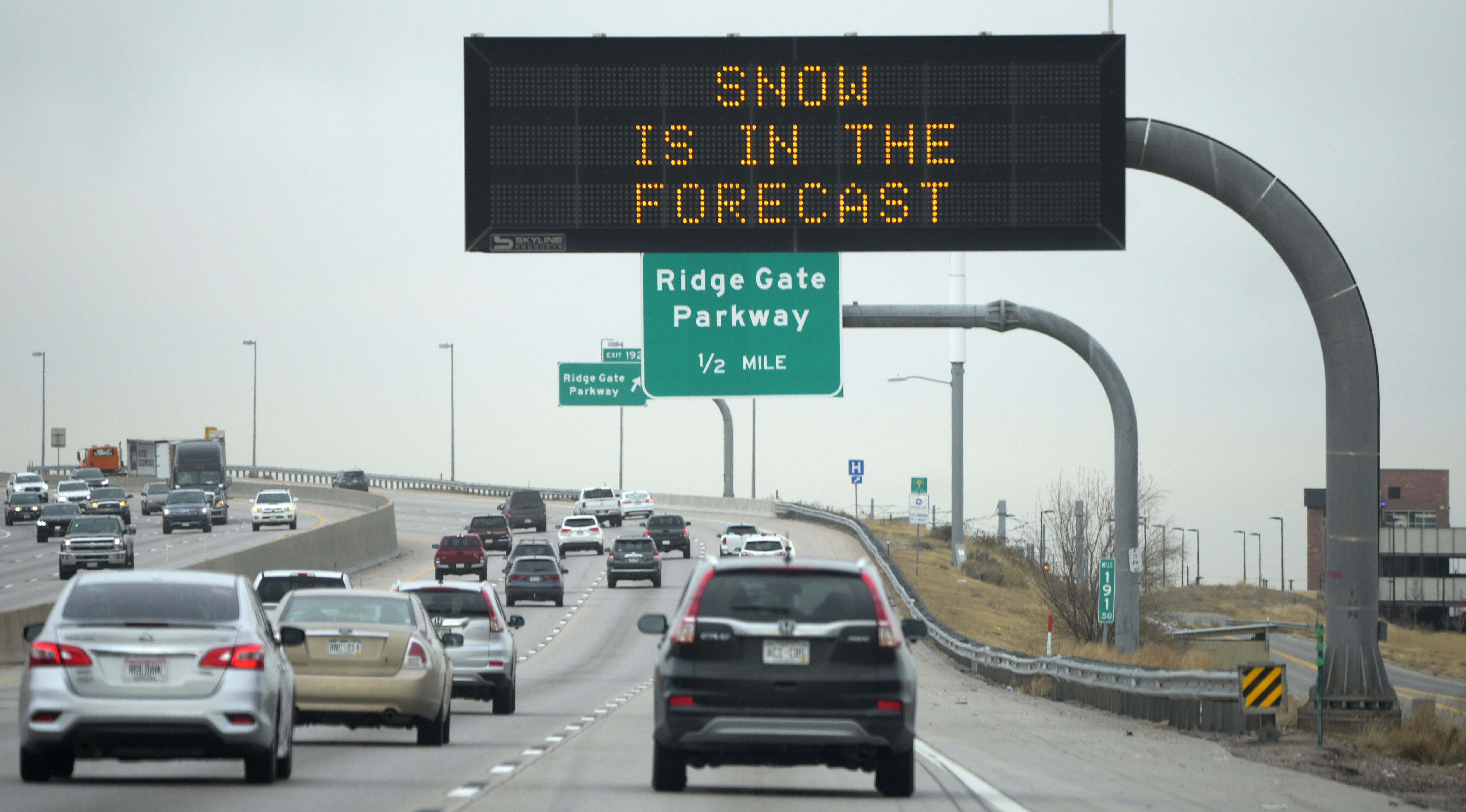 Electronic overhead sign advises motorists to take caution on northbound Interstate 25 at Ridgegate Parkway