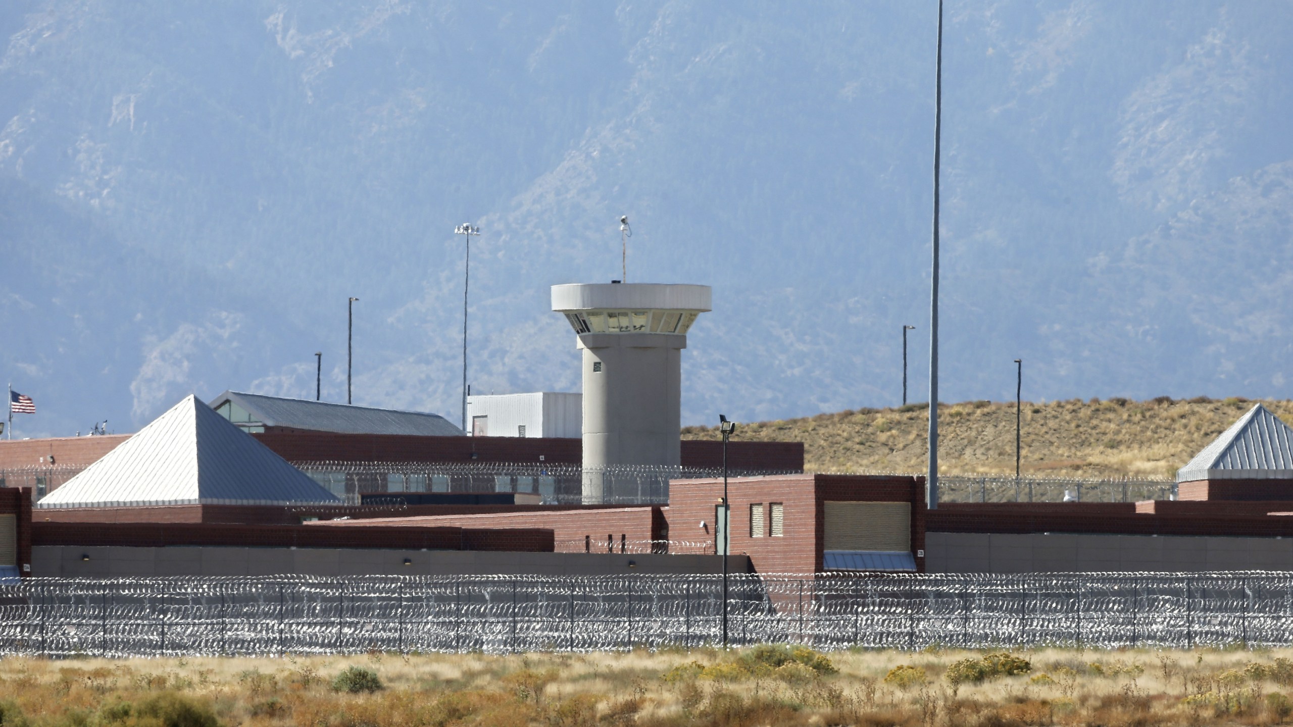 a guard tower looming over a federal prison complex