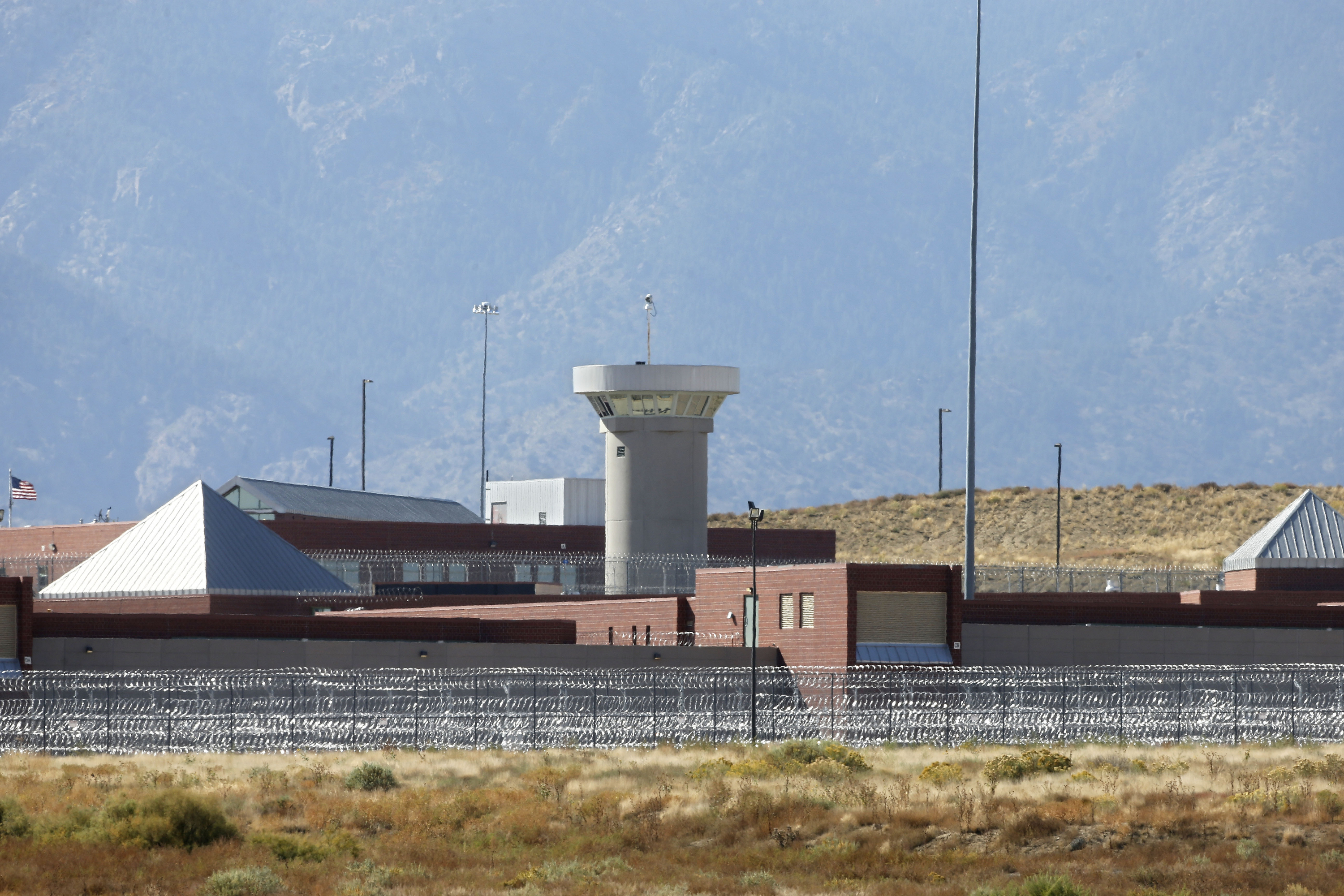 a guard tower looming over a federal prison complex