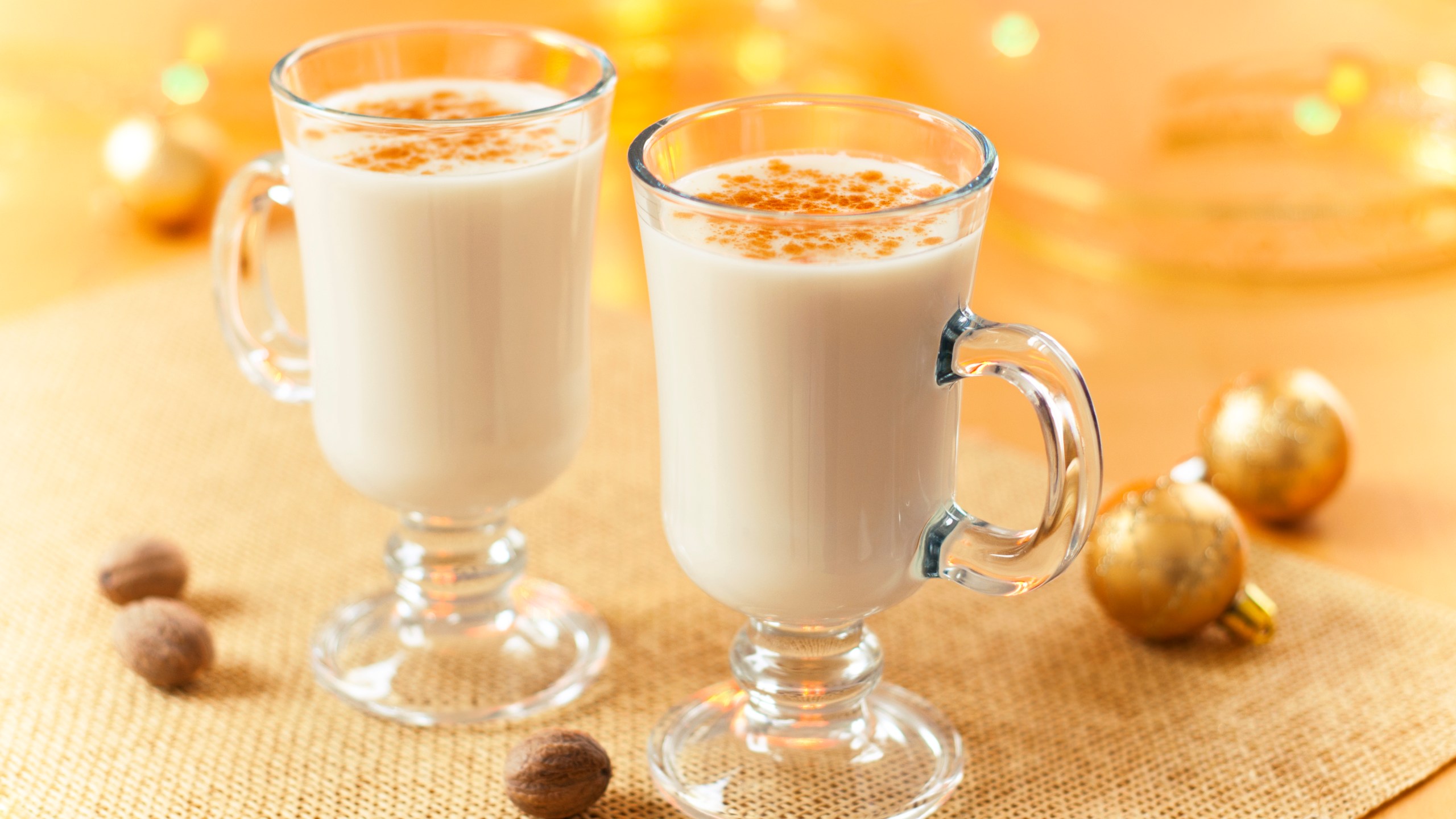 Two large glasses of eggnog served beautifully