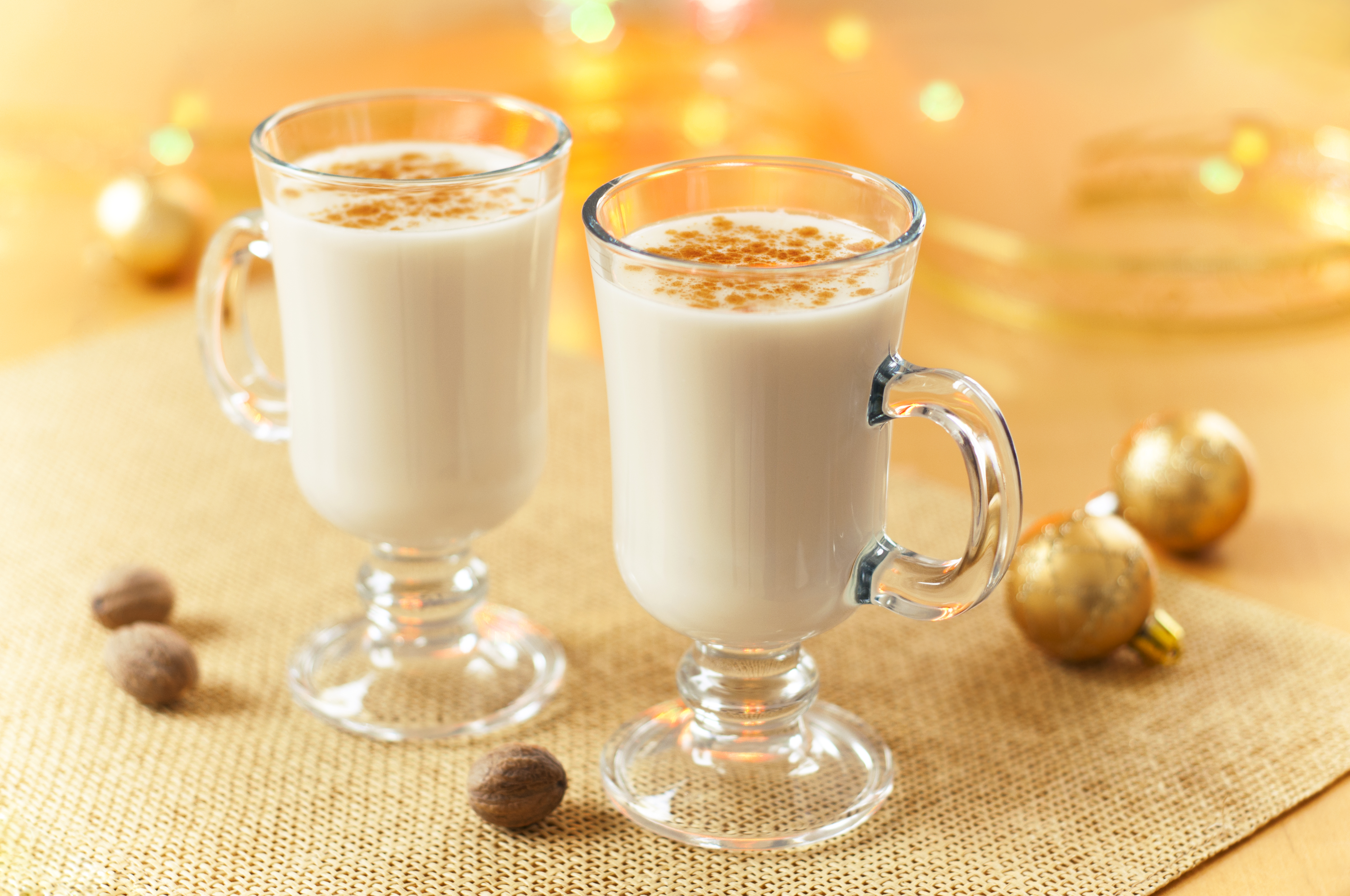 Two large glasses of eggnog served beautifully