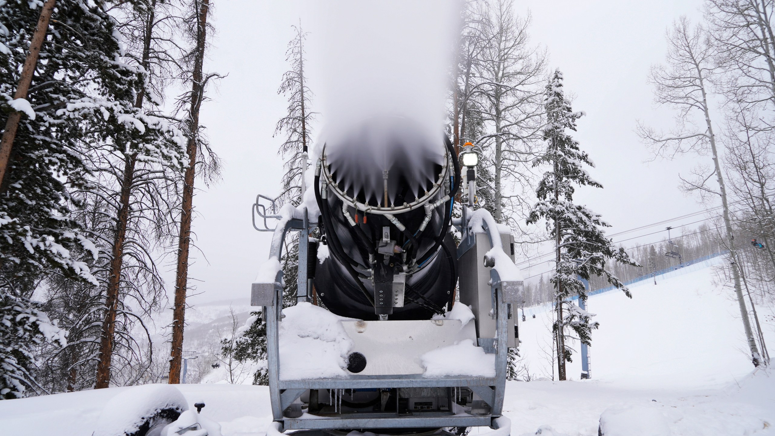 A machine blows snow at Vail Mountain Resort