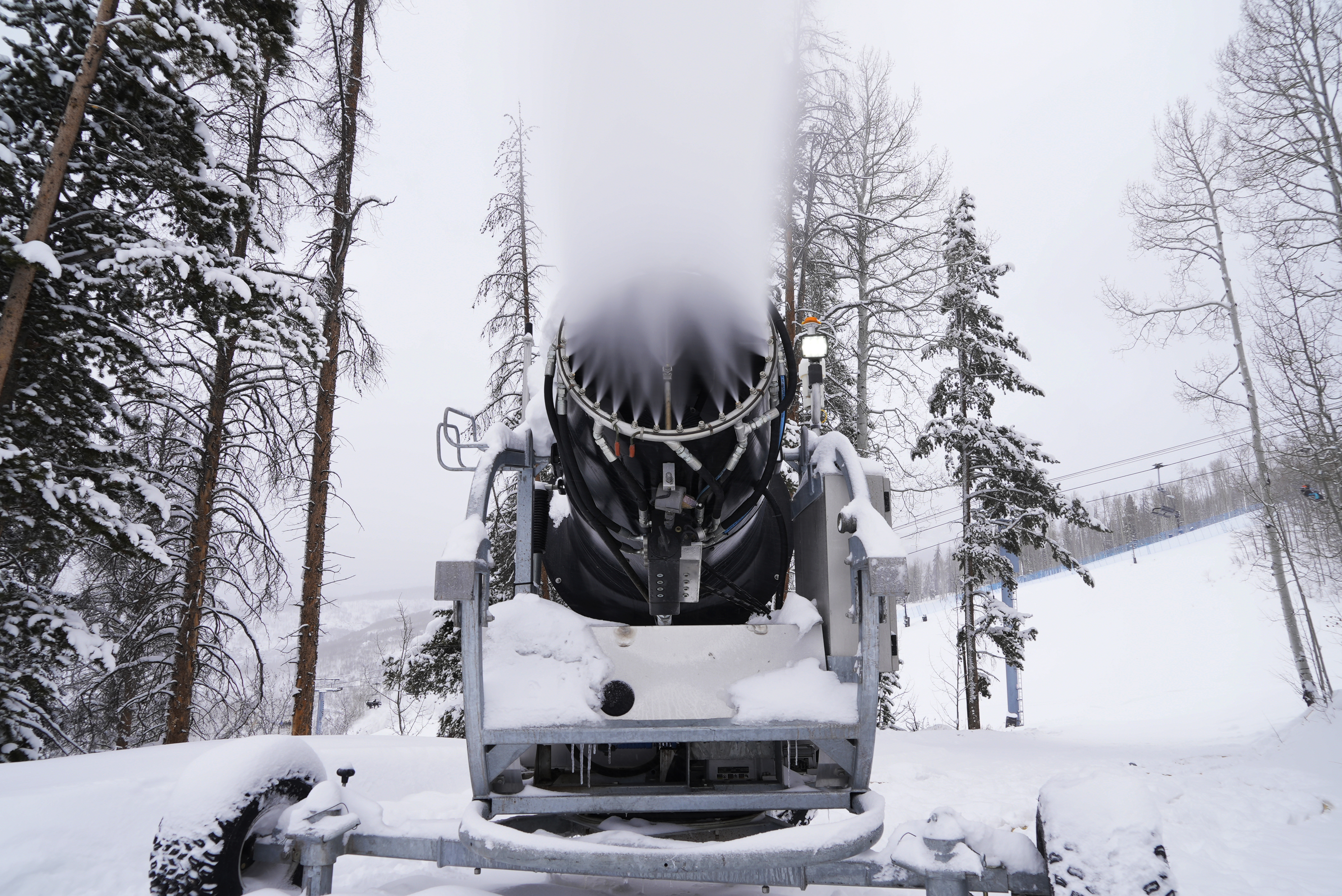 A machine blows snow at Vail Mountain Resort